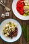 Greek style salad - feta cheese and kalamata olives on wooden table