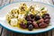 Greek style salad - feta cheese and kalamata olives on wooden table