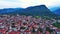 Greek town of Litochoro with small houses against the backdrop of the Mount Olympus and a cloudy sky