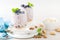 Greek yogurt or blueberry parfait with fresh berries and almond nuts on white background