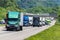 Green 18-Wheeler Leads Heavy Highway Traffic