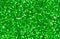 Green abstract background. Green glitter closeup photo. Green shimmer wrapping paper.