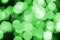 Green abstract Christmas blurred luminous background. Defocused artistic bokeh lights image