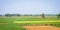 Green agriculture field horizon against blue sky background. Panoramic landscape Scenery. West Bengal India South Asia Pacific