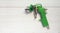 Green air compressor gun. Isolated on a wooden background