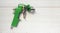 Green air compressor gun. Isolated on a wooden background