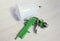 Green air compressor gun. Isolated on a wooden background