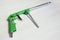 Green air compressor gun. Isolated on a wooden background