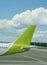 Green airplane at Riga airport at day.