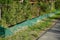 A green Amphibian protection fence is installed near the road. Berlin, Germany