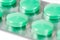 Green analgesic pills in blister
