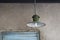 Green ancient lamp against blue stucco wall and frame