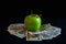 Green apple on dollars cash