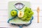 Green apple, fresh vegetable with weight scale and measuring tape for the healthy diet slimming
