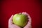 Green apple held by hand