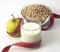 Green Apple, Kefir and Oatmeal with Measuring tape on white background