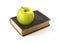 Green apple lies on the physics book of Isaac Newton