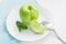 green apple and mint on a white plate
