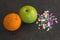 Green Apple and orange next to the vitamin tablets and supplements. Medicine and healthy. Different kind of pills.