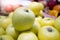 Green apple pile on shelf at supermarket