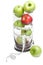 Green apple and red apple with measuring tape in glass bowl