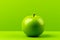a green apple sitting on a table in front of a bright green background