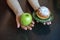 green apple and sugar donut in the hands, the dilemma of what to choose, the concept of healthy eating and lifestyle, the problem