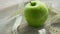 Green apple and tape measure