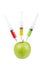 Green apple with three syringes inserted