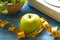 Green apple with weight scale and measuring tape for the healthy diet slimming