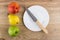 Green apple, yellow pear and nectarine, empty plate and knife