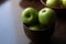 Green apples on a brown wooden table. Text space