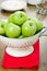 Green apples in a colander.
