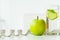 Green apples, glass water with mint leaves, lemon and cucumber,