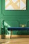 Green apples in golden bowl on velvet bench in green living room interior