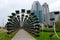 Green arch in the Flower Park of the city of Grozny, Chechnya, Russia. Building of the complex Grozny City in the background