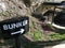 Green area, informative sign indicating the entrance to the German bunker from the Second World War