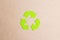 Green arrows recycle eco symbol on brown paper background