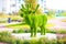 Green artificial topiary in the form of an animal elk in the yard, decoration of playgrounds and local areas