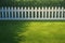 Green artificial turf Wide angle view of white picket fence yard