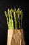 Green asparagus in a brown paper bag