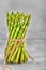 Green Asparagus. Bunches of green asparagus on gray concrete background