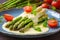 green asparagus with cream sauce, on a plate with tomatoes and parsley.Generated image