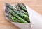 Green asparagus from a farmers market in brown paper packaging -