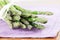 Green asparagus on purple napkin