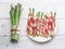 Green asparagus sprouts wrapped in ham on wooden table. Top view