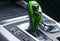 Green Automatic gear stick of a modern car. Modern car interior details. Close up view. Car detailing. Automatic transmission leve