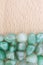 Green Aventurine heap jewel on half light varnished wood texture