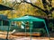 Green awning in the forest. Inverted wooden boat. A holiday vill
