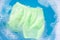 Green baby shorts soak in baby laundry detergent water dissolution, washing cloth, Laundry concept